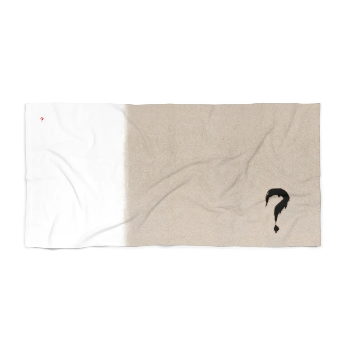 White-and-sand-colored beach towel with small red and large black question marks.