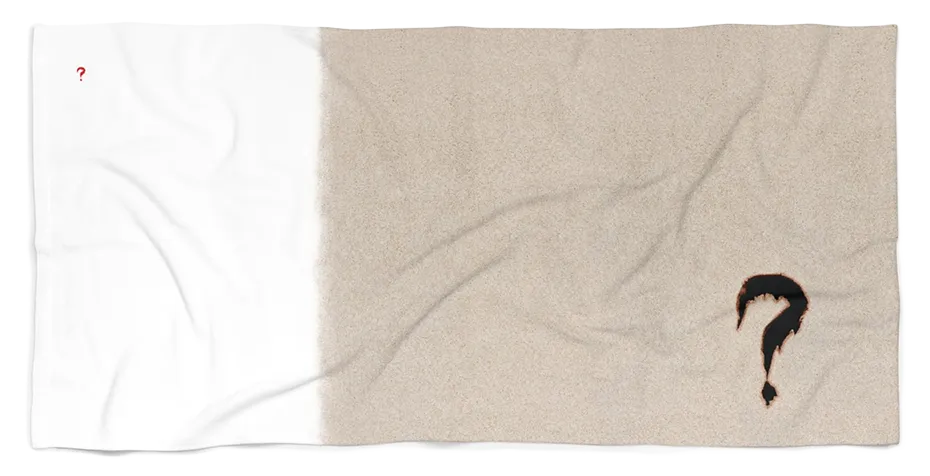 White-and-sand-colored beach towel with small red and large black question marks.